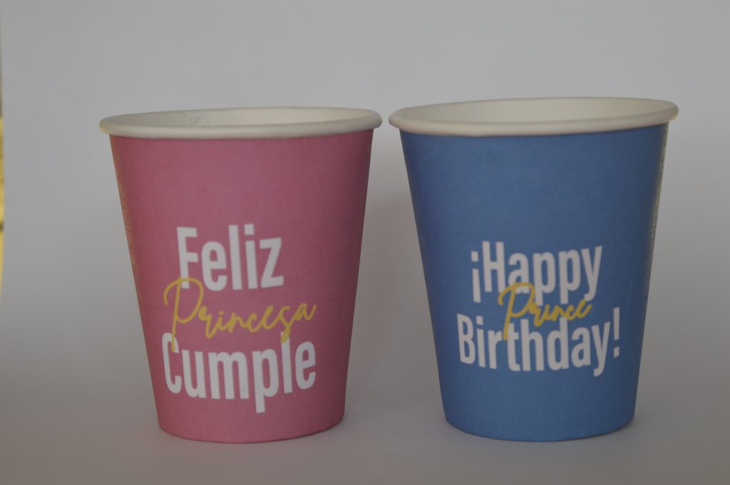 Par de vasos con fondo de color, vaso rojo con letreo de happy birthday princess y vaso azul con letrero de feliz cumple principe